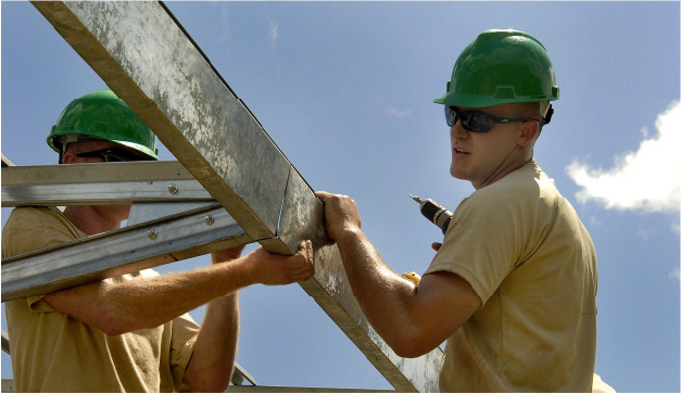 Two men installing a ramp