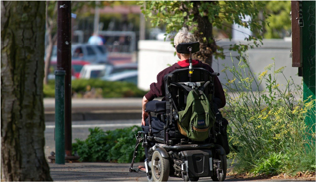 A man riding a powered wheelchair
